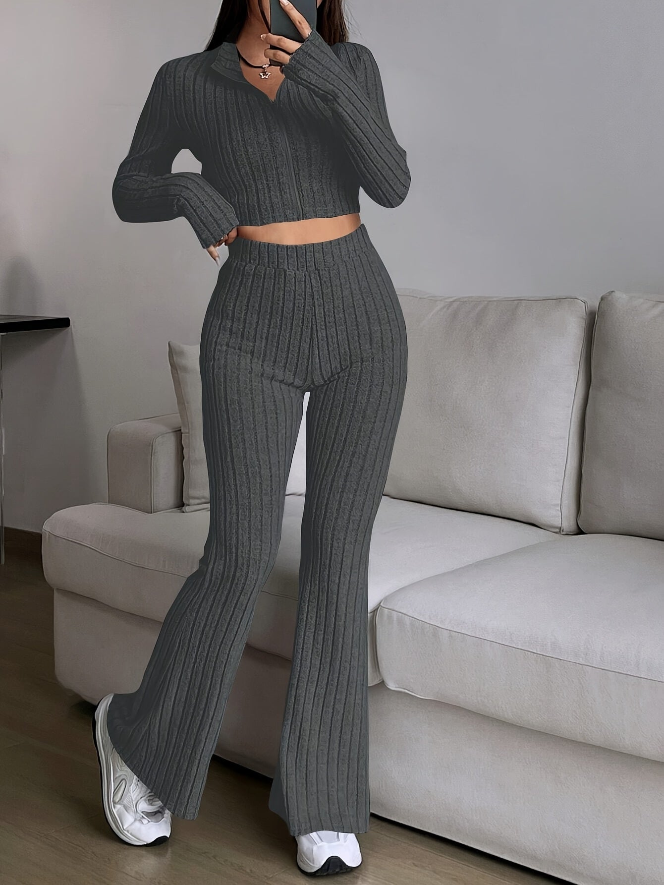 Two-piece ribbed zip-up crop top and flared pants set for women