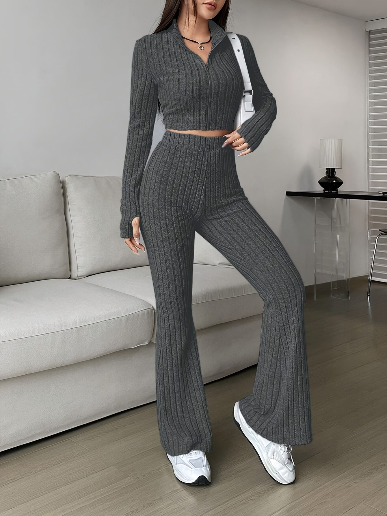 Two-piece ribbed zip-up crop top and flared pants set for women
