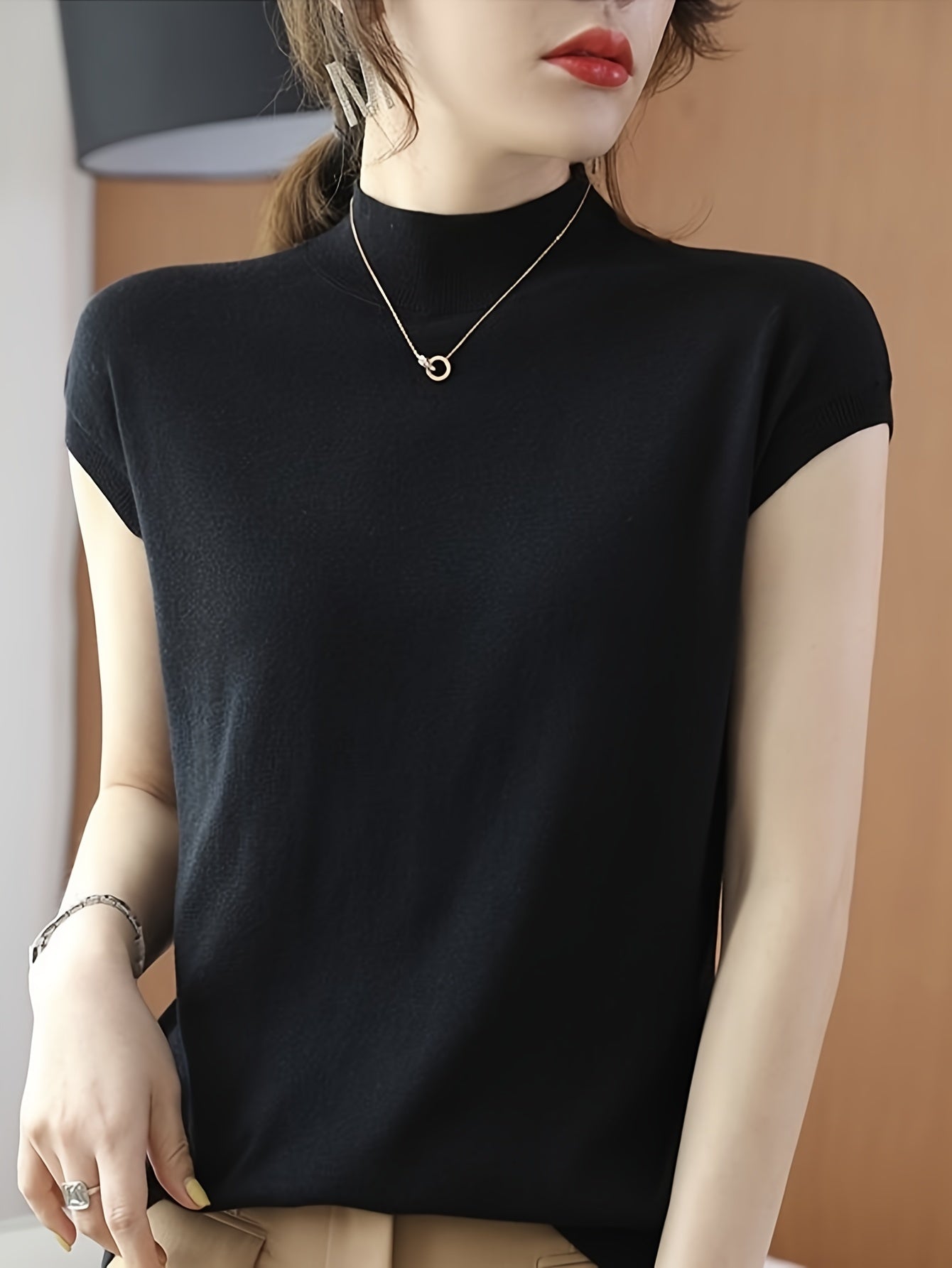 Sleeveless high-neck knit top with a fitted design for women