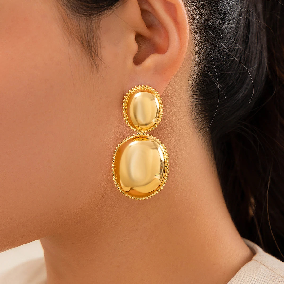 Trendy gothic ball drop earrings with piercing detail