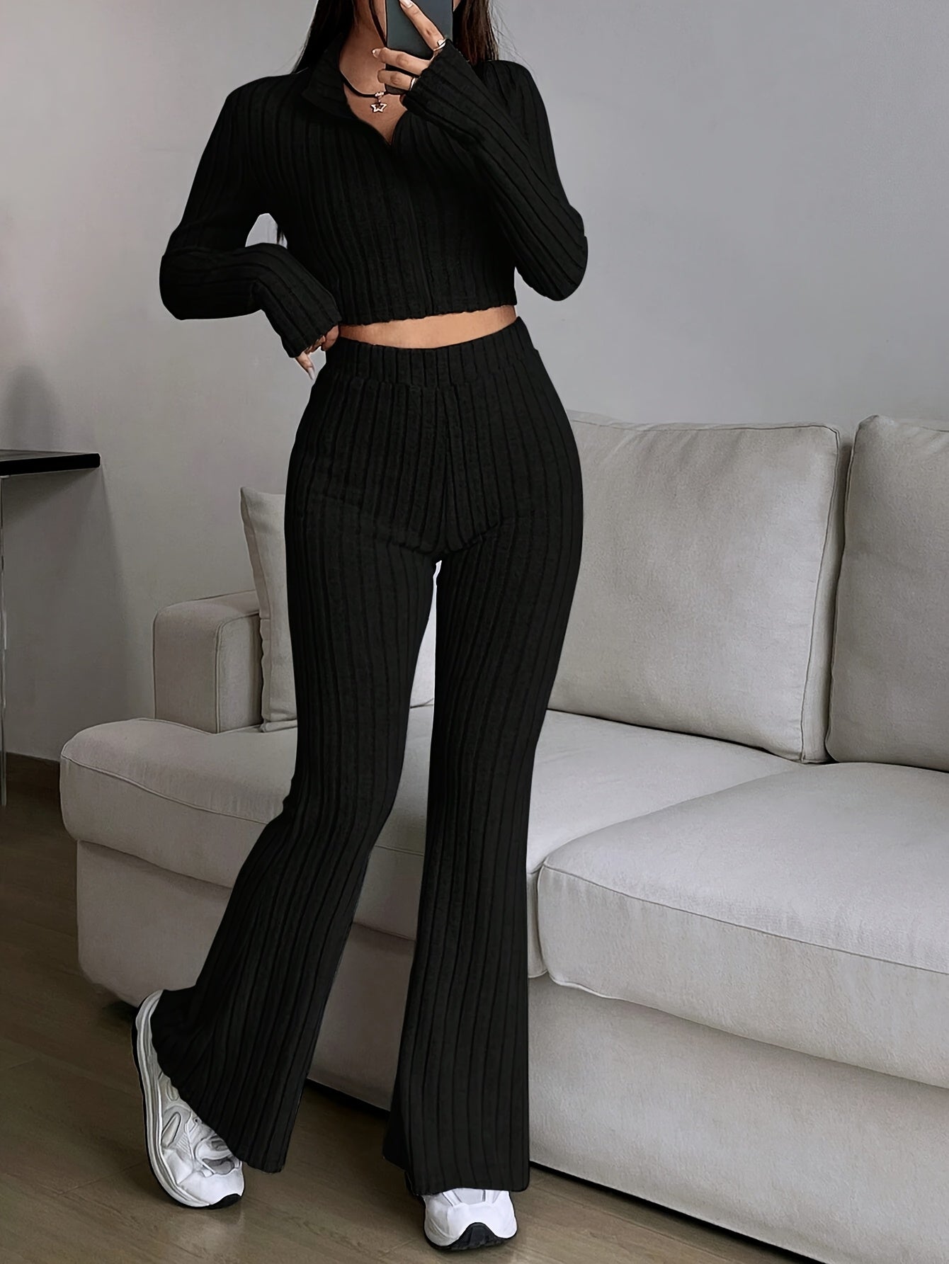Two-piece ribbed zip-up crop top and flared pants set for women