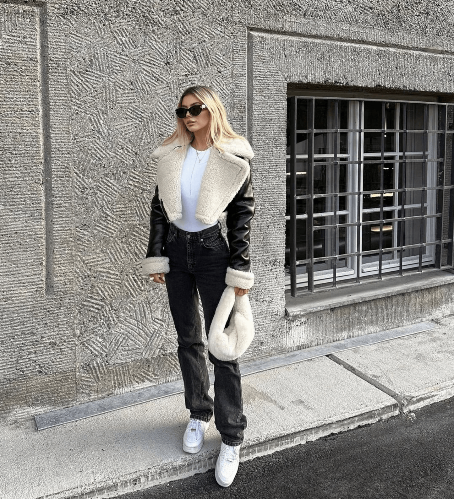 Women's black leather jacket with white fur