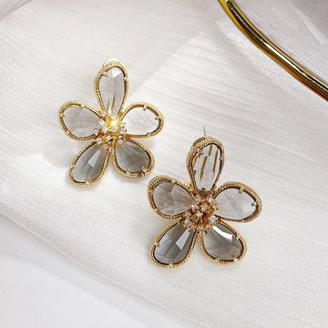 Rotating floral earrings with embedded zirconia