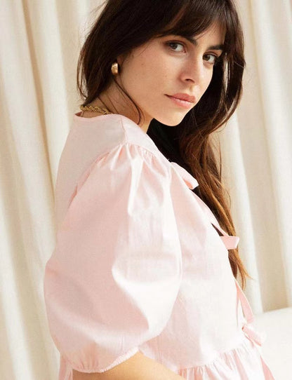Women's puff-sleeve peplum bow top