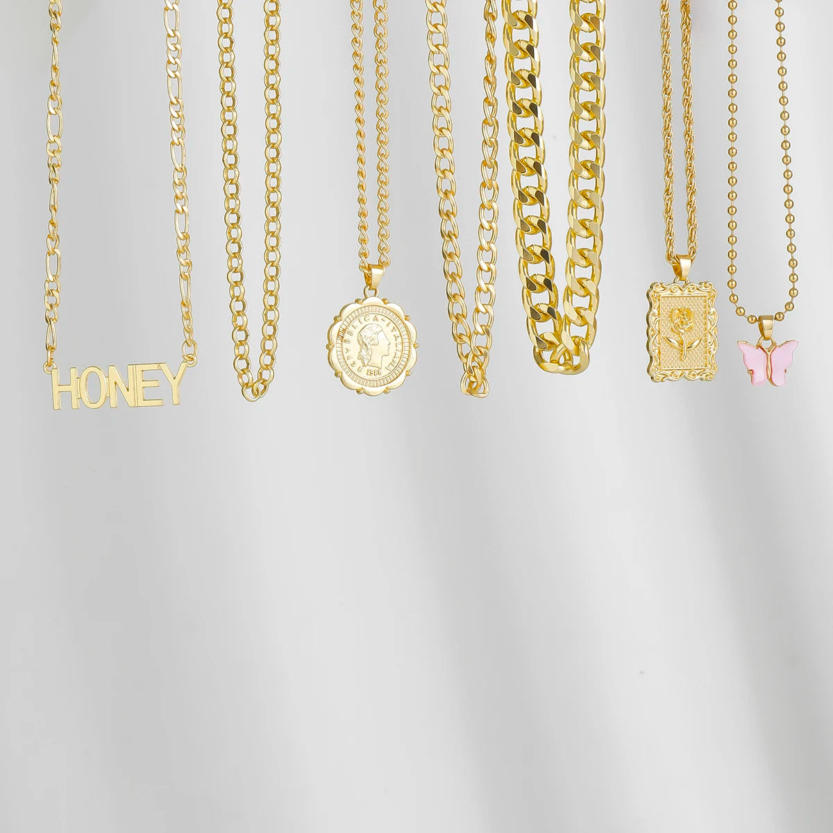 Gold layered chain necklace set with "Honey" pendant