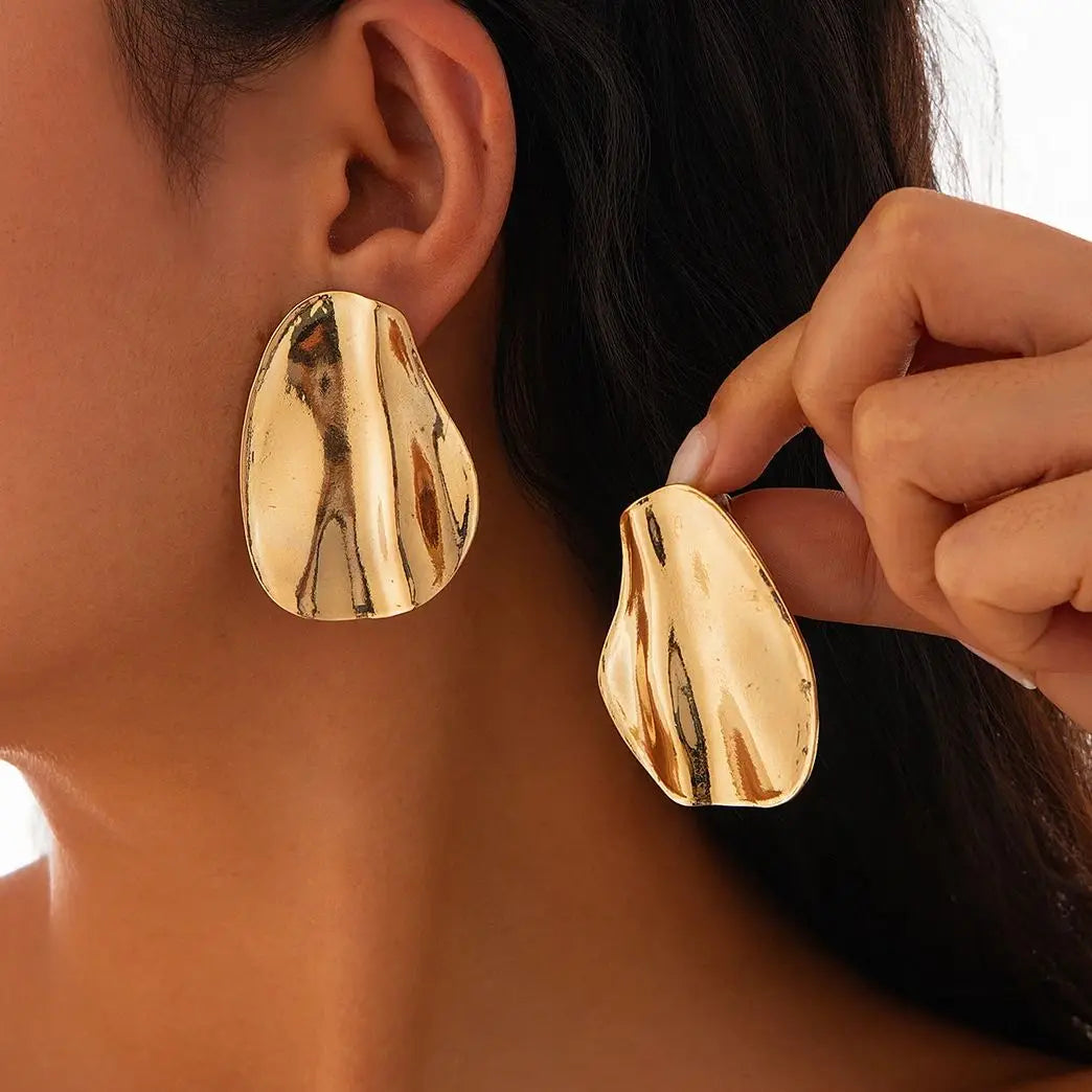 Abstract statement earrings with a sculpted metal design