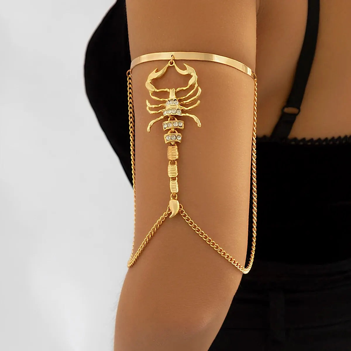 Gold scorpion arm cuff with chain details