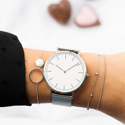 Minimalist mesh band quartz watch with ultra-slim dial for women