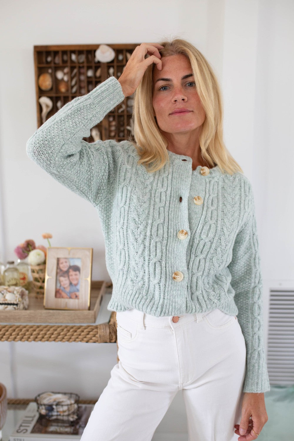 Fresh blue knitted sweater with crew neckline with button closure